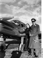 German Luftwaffe Lieutenant Colonel Theodor Osterkamp and his wife posing with a Me 108 Taifun aircraft, Dec 1938