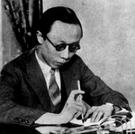 Puyi writing at a desk, China, circa 1920s