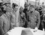 Wang Jingwei studying a map with military officers and government officials, China, 1940s; note presence of Japanese Army officers