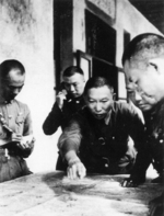 Xue Yue studying a map with his staff officers, China, circa 1940s