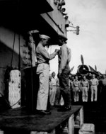US Navy Captain Herbert W. Taylor of USS Cowpens awarding African-American Stewards Mate 3rd Class Fred Magee, Jr. with commendation of the Secretary of the Navy, Oct 1944