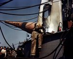 Shipyard worker working on a turret aboard battleship Iowa, New York Navy Yard, New York, United States, fall 1942