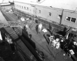 USS Permit at Mare Island Navy Yard, California, United States, 12 Jan 1943; note crewmen unpacking supplies, among them Sunkist brand oranges