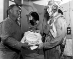 Captain Dixie Kiefer of USS Ticonderoga presenting VT-80 pilot Clyde Grow a cake for making the 6,000th landing on the carrier (