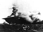 Wasp (Wasp-class) burning and listing after being torpedoed by Japanese submarine I-19 in the South Pacific, 15 Sep 1942. Photo 1 of 2.