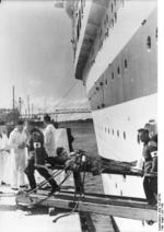 Two medics unloading a wounded German soldier from hospital ship Wilhelm Gustloff, Jul 1940