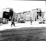 US Army CCKW 2 1/2-ton 6x6 cargo trucks unloading supplies from US Navy LSTs in Marseille, France, Sep 1944