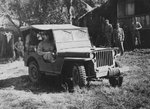 General Douglas MacArthur in a Ford GPW Jeep at US 43rd Division Command Post area, Philippine Islands, 1945