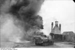 German SdKfz. 251/16 No. 644 halftrack vehicle torching a building with a flamethrower, Russia, Aug 1944, photo 2 of 3
