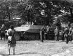 Polish resistance fighters with captured German SdKfz. 251 halftrack vehicle, Okólnik gardens, Warsaw, Poland, 14 Aug 1944; Capitan Cyprian Odorkiewicz and Wacław Jastrzębowski were present among the group on the right side of the photograph
