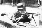 Chinese soldier with a ZB vz. 26 light machine gun in an urban street, China, circa late 1930s