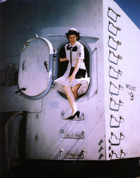 WAVES Yeoman Third Class Betty Martin exiting the rear door of a 5in twin gun turret aboard Missouri, Norfolk Navy Yard, Virginia, United States, during her shakedown period, 19 Aug 1944