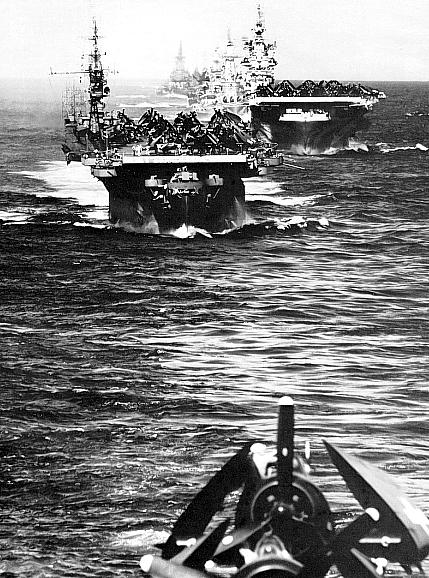 US Navy Task Group 38.3 entering Ulithi anchorage in a column following strikes in Philippine Islands, 24 Dec 1944, photo 1 of 7