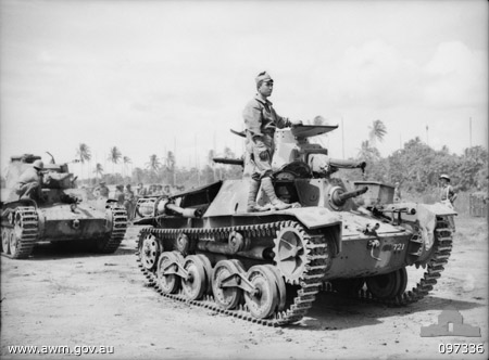 Japanese tank crew bringing a Type 95 Ha-Go light tank to men of Australian 2/4 Armoured Regiment after surrendering Rapopo Airfield, New Britain, Solomon Islands, 28 Sep 1945
