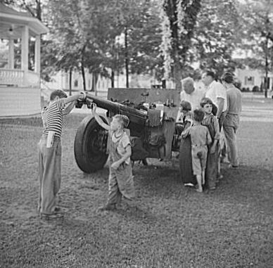Civilians looking at a French-built 75mm field gun, Bristol, Vermont, United States, Jul 1940