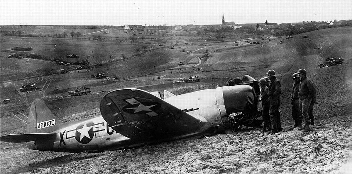 P-47D Thunderbolt of the 367th Fighter Squadron made a belly landing in field artillery position after being hit in the left wing during a dive bombing attack on near Würzburg, Germany, 1 Apr 1945.  The pilot was only slightly injured.