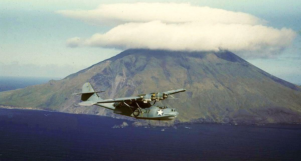 PBY-5A Catalina patrol plane flying past Segula Island (just east of Kiska), Aleutians, Summer 1942.