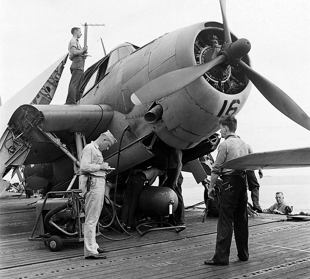 TBM-1 Avenger on a carrier deck, 1942-44. Note Mark XIII torpedo and crewman on top of the airplane handling an antenna from the ASB radar system.