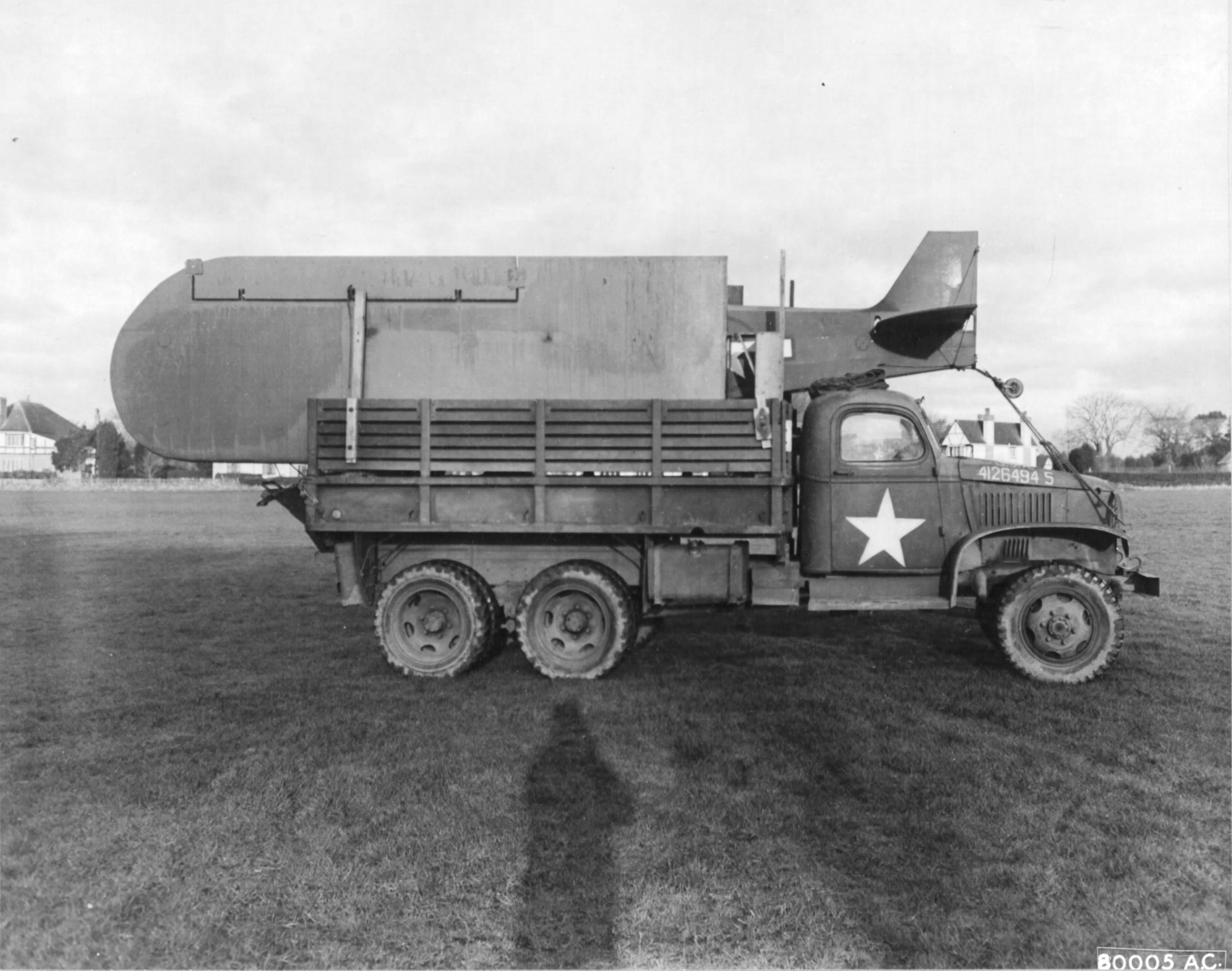 Piper L-4 Grasshopper observation aircraft on a 2.5 ton CCKW truck in preparation for the D-Day landings. Devon, England, United Kingdom, Feb 12 1944.