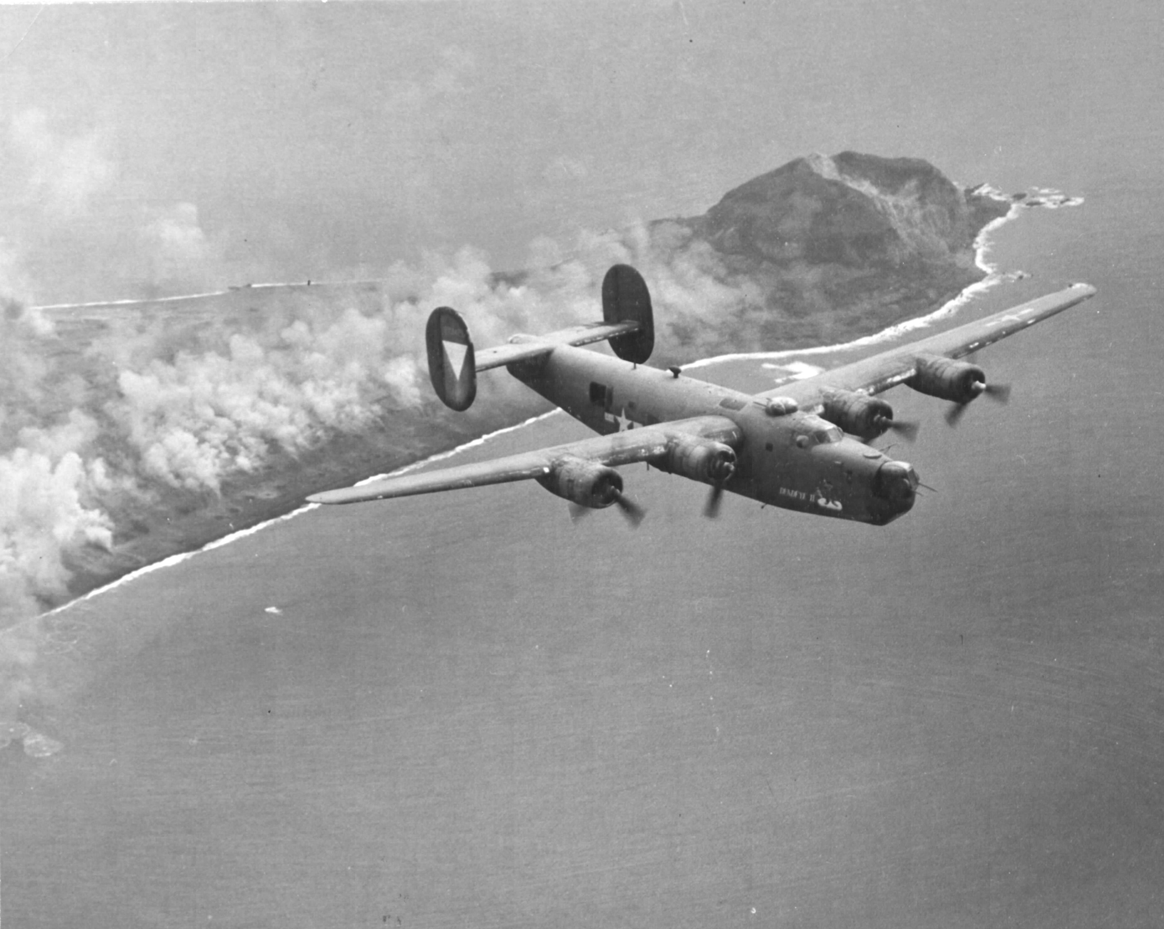 B-24J Liberator “Deadeye II” of the 392nd Bomb Squadron flown by Lt. Warren Myllenbeck flying from Saipan, Mariana Islands, overflying Iwo Jima and Mt Suribachi, 1944-45.
