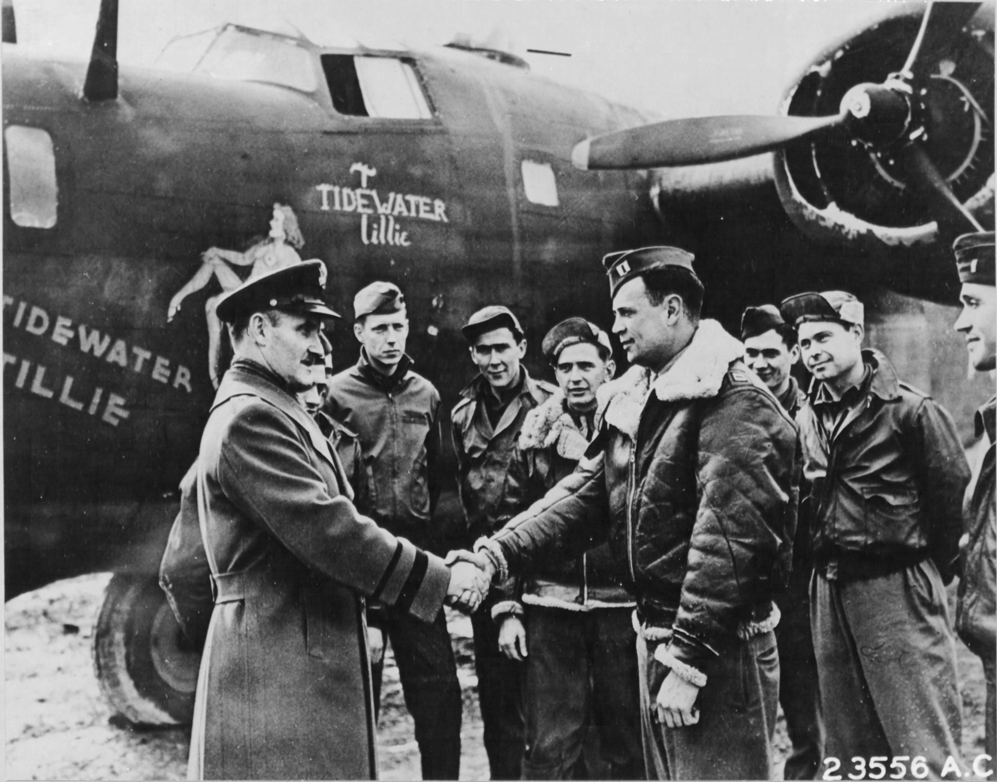 BGen Westside T Larson, CO of Antisub Command in England, commends Capt Jack H Shaw, Navigator of B-24D Liberator “Tidewater Tillie,” at RAF St Eval, Cornwall, England after the aircraft sank a German U-Boat in the Bay of Biscay.