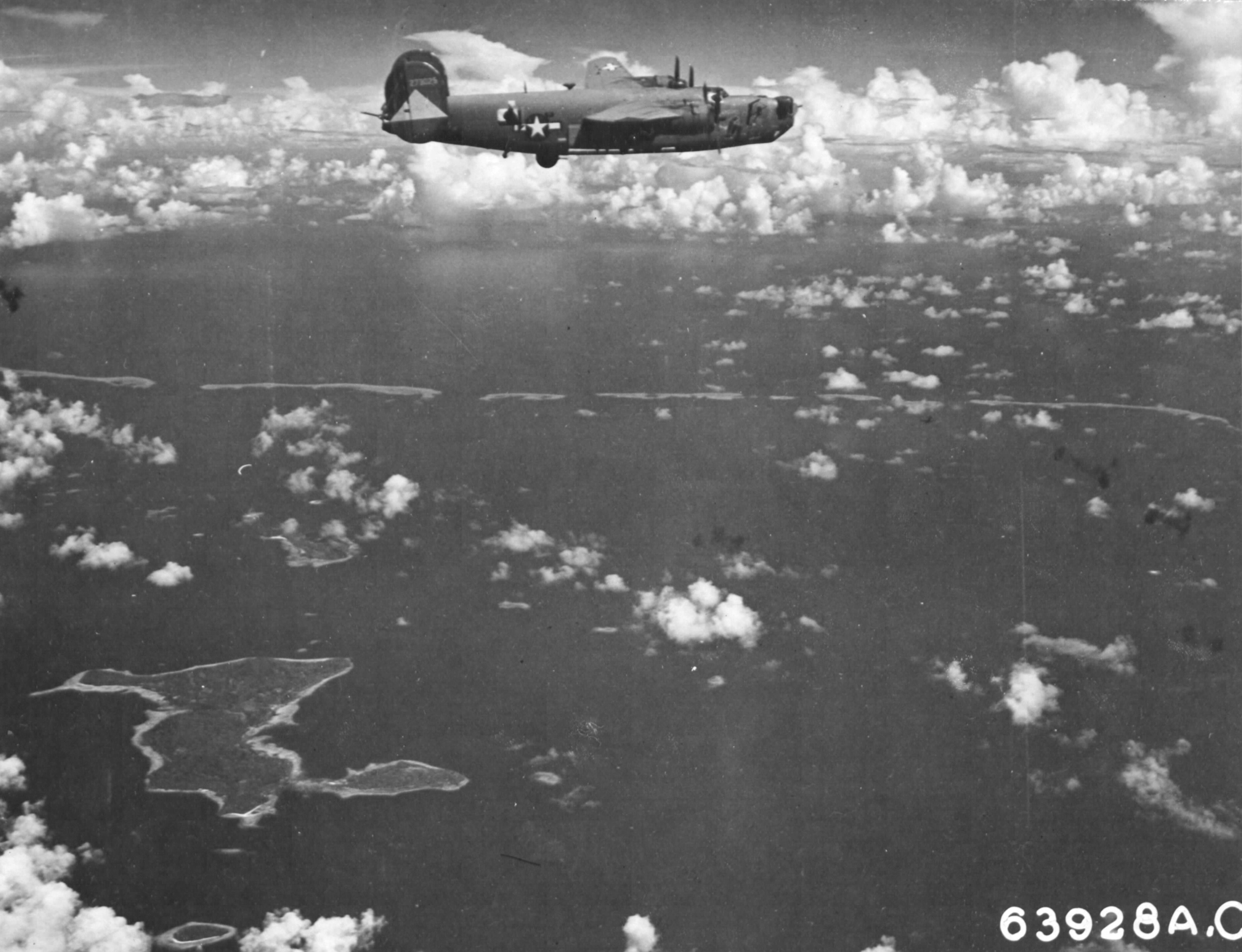B-24J Liberator “Kansas Cyclone” of the 26th Bomb Squadron approaching targets in and around the Truk Lagoon, Caroline Islands, 1944. Note Udot Island below.