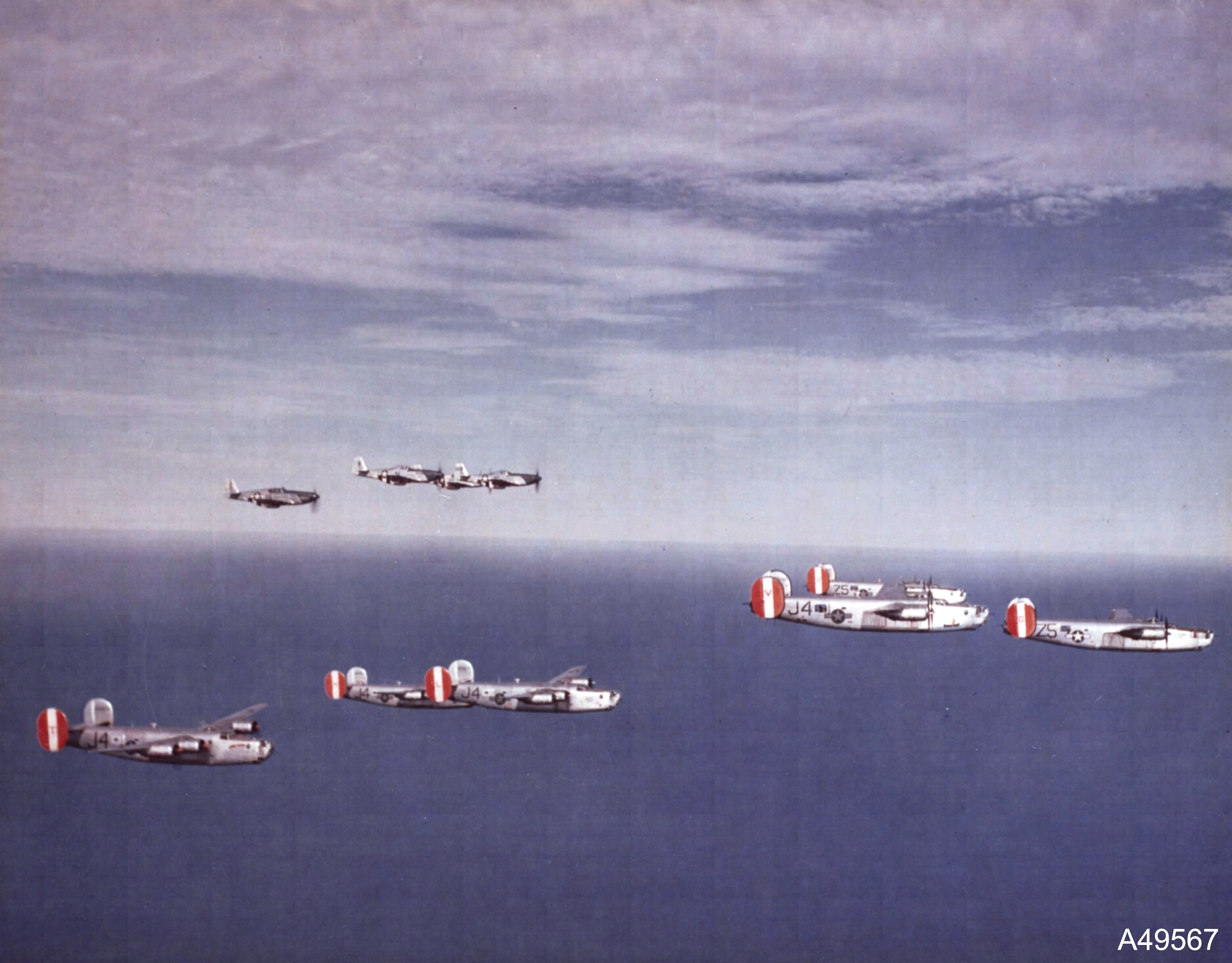B-24 Liberators of 458th Bomb Group are escorted by P-51 Mustangs of the 486th Fighter Squadron, 1944-45. Photo 2 of 2.