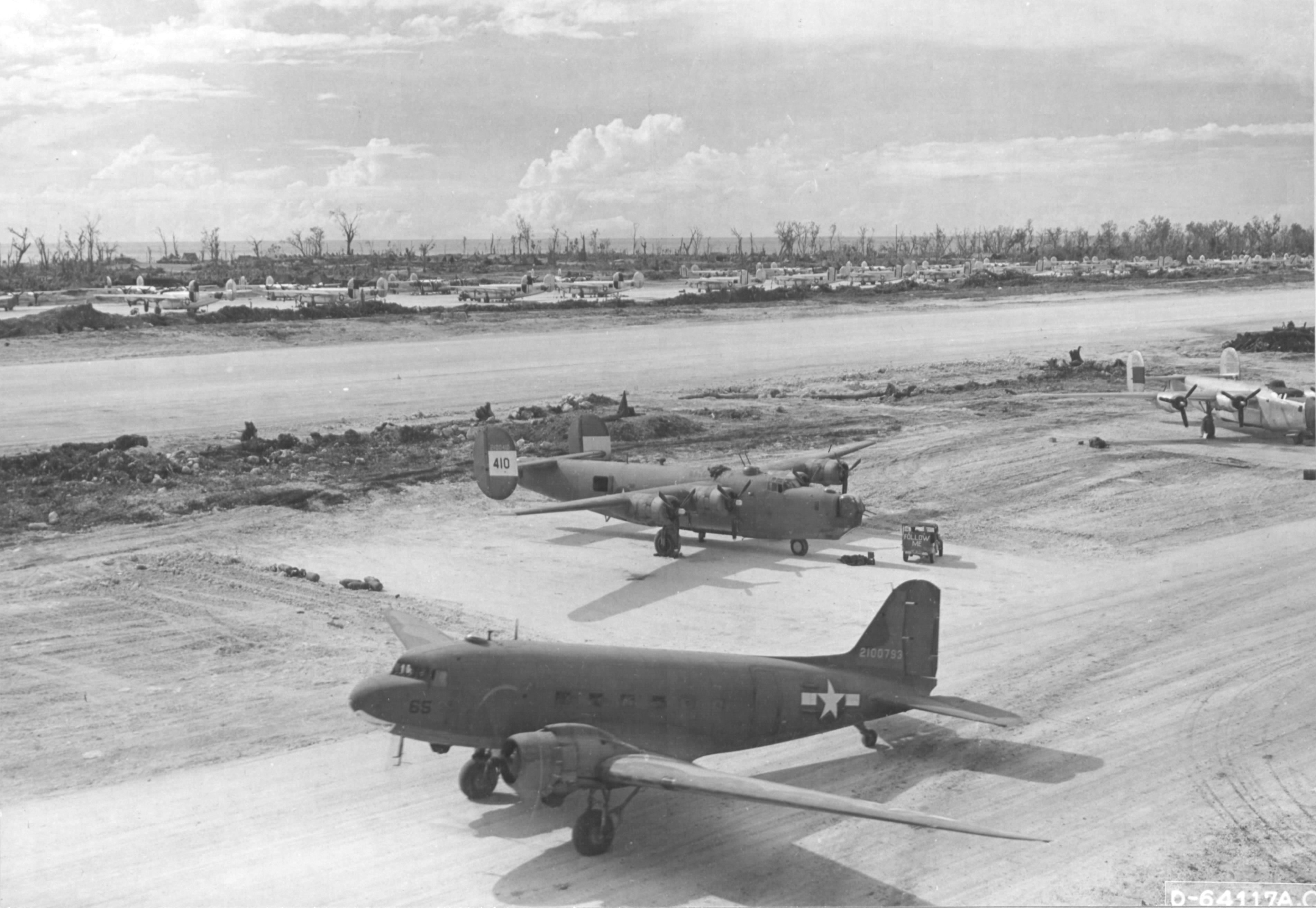 The airstrip at Angaur, Palau Islands Dec 9 1944 with B-24Js of the 22nd Bomb Group on the near side and B-24s of the 494th Bomb Group on the far side; plus one C-47A Skytrain supply aircraft.