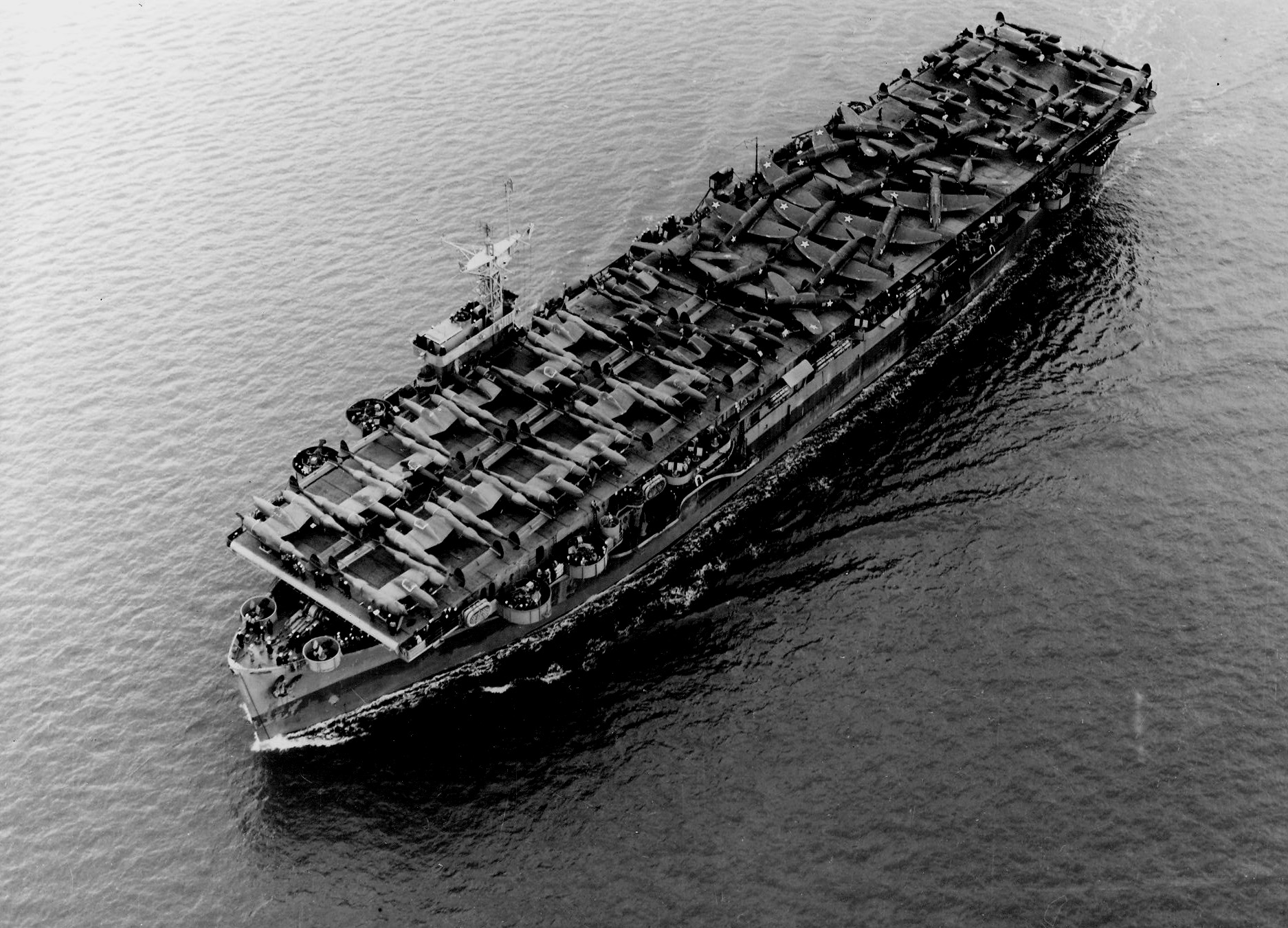 Escort Carrier USS Barnes transporting P-38 Lightning and P-47 Thunderbolt fighter planes across the Pacific, July 1 1943
