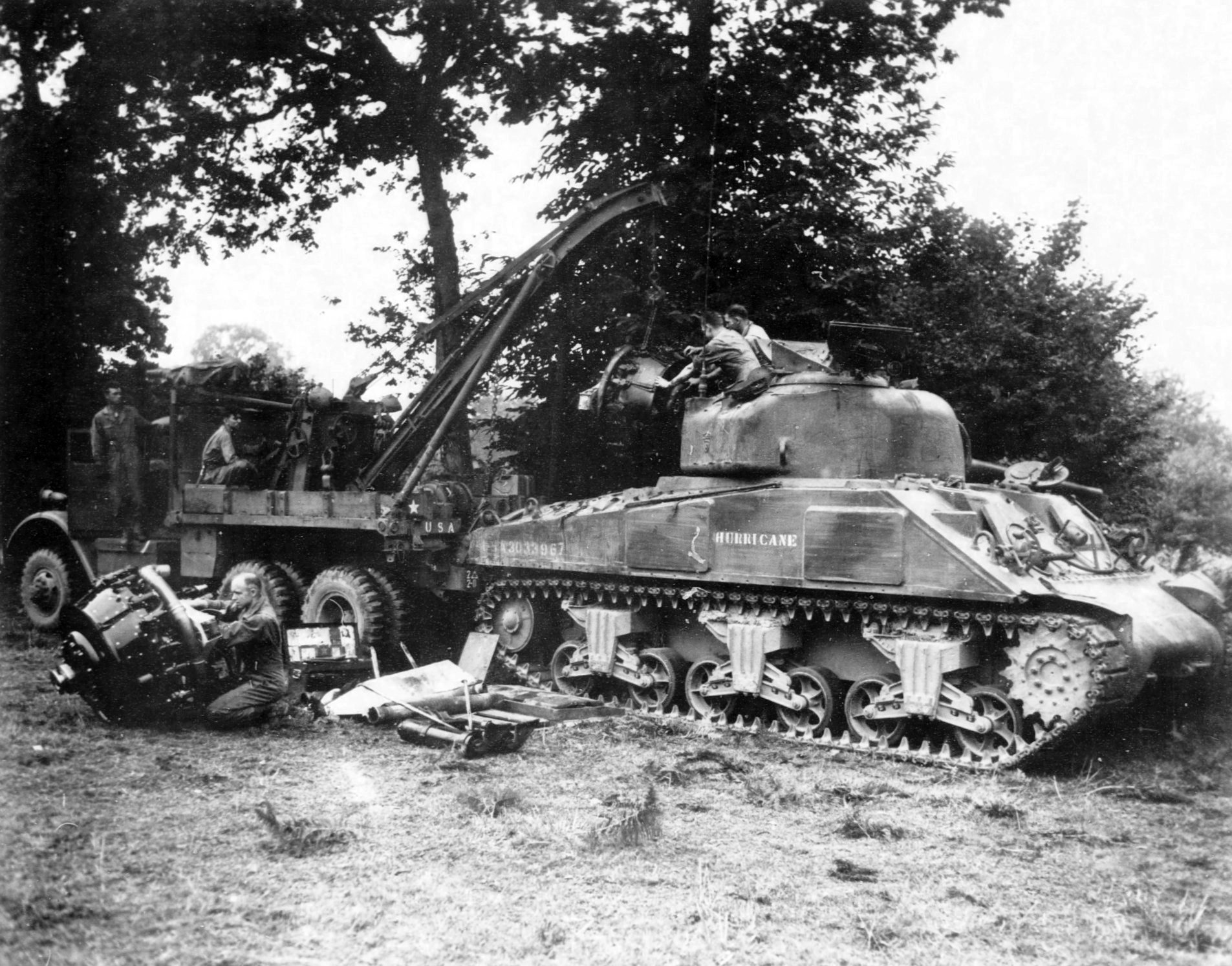 Engine change for M4 Sherman tank “Hurricane” at a repair depot near the front lines, Le Teilleul, France, July 1944. Note Federal C-2 Wrecker