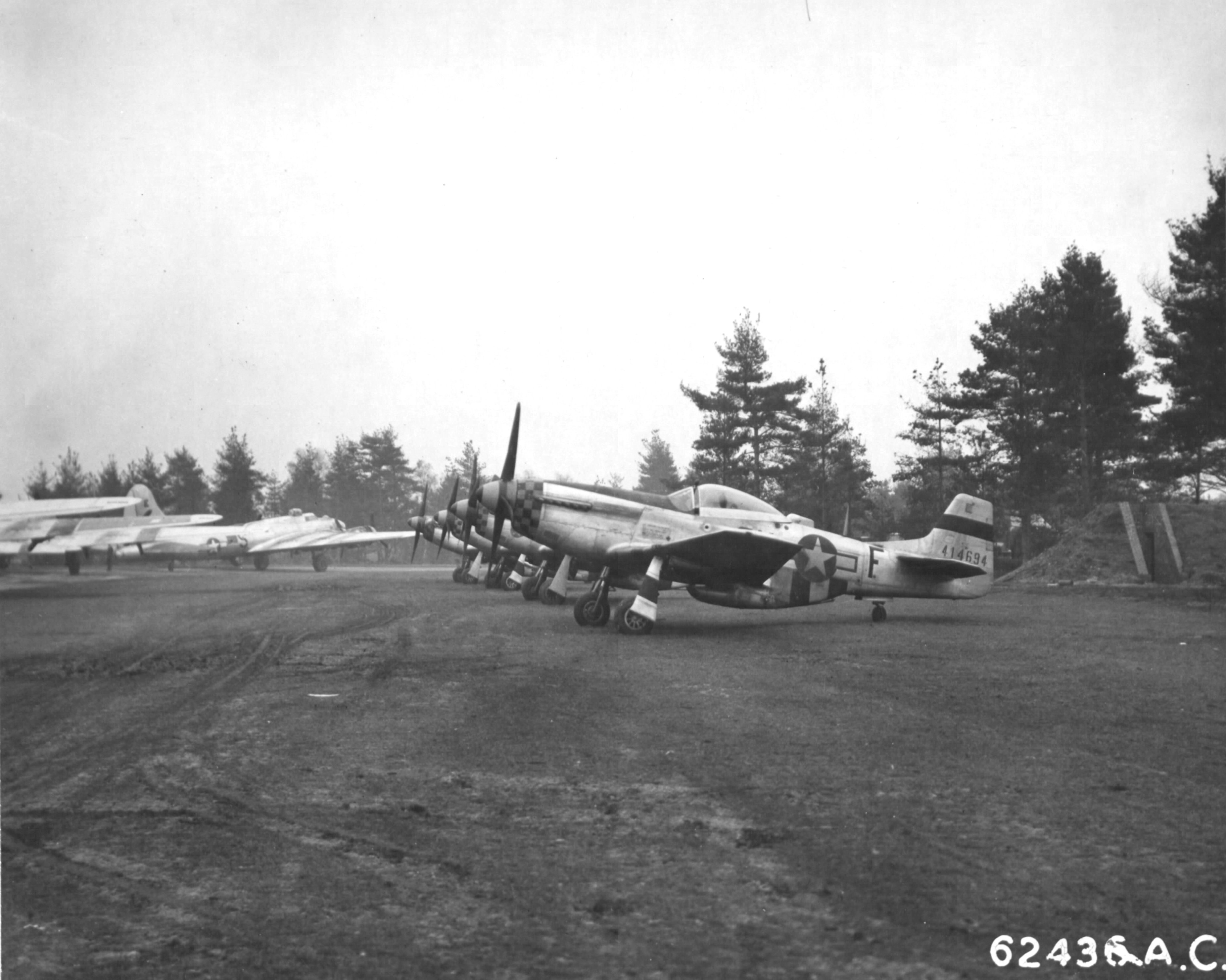 P-51D Mustangs of the 353rd Fighter Group in a line at a B-17 Fortress base of the 493rd Bomb Group, RAF Debach, Suffolk, England, UK, June 1945.
