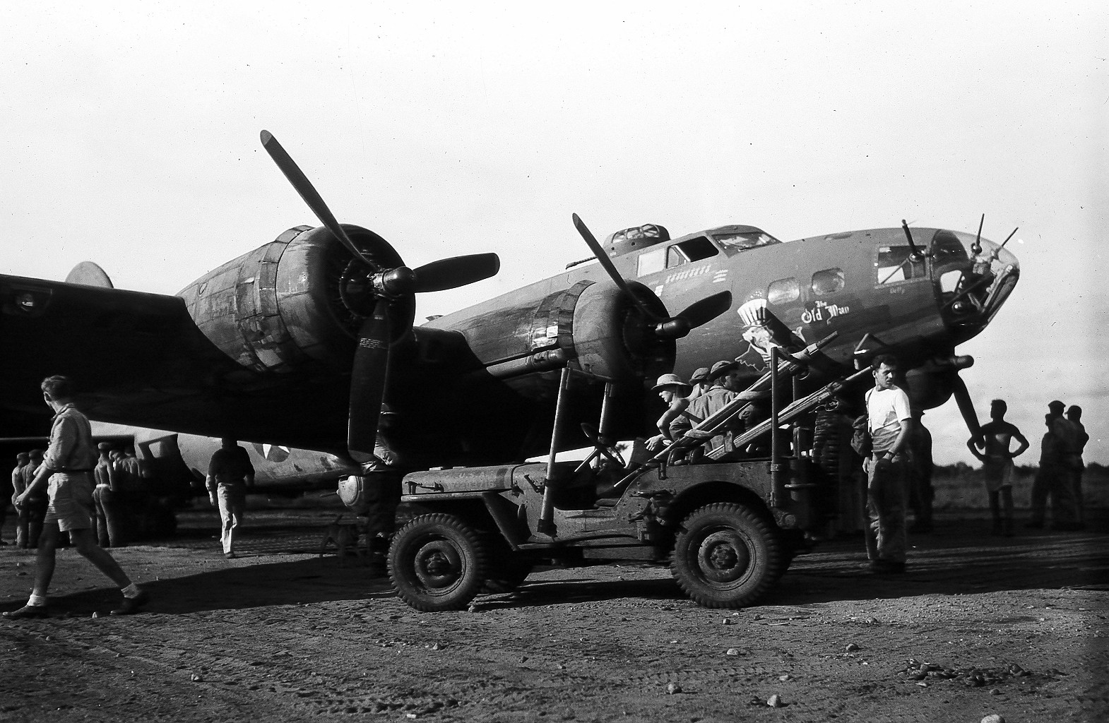 A Jeep brought litters to the B-17F Fortress “The Old Man” of the 65th Bomb Squadron shortly after landing at Dobodura, New Guinea, Mar 8 1943. The B-17 was attacked by 13 Japanese fighters during a photo-recon mission over Gasmata, New Britain