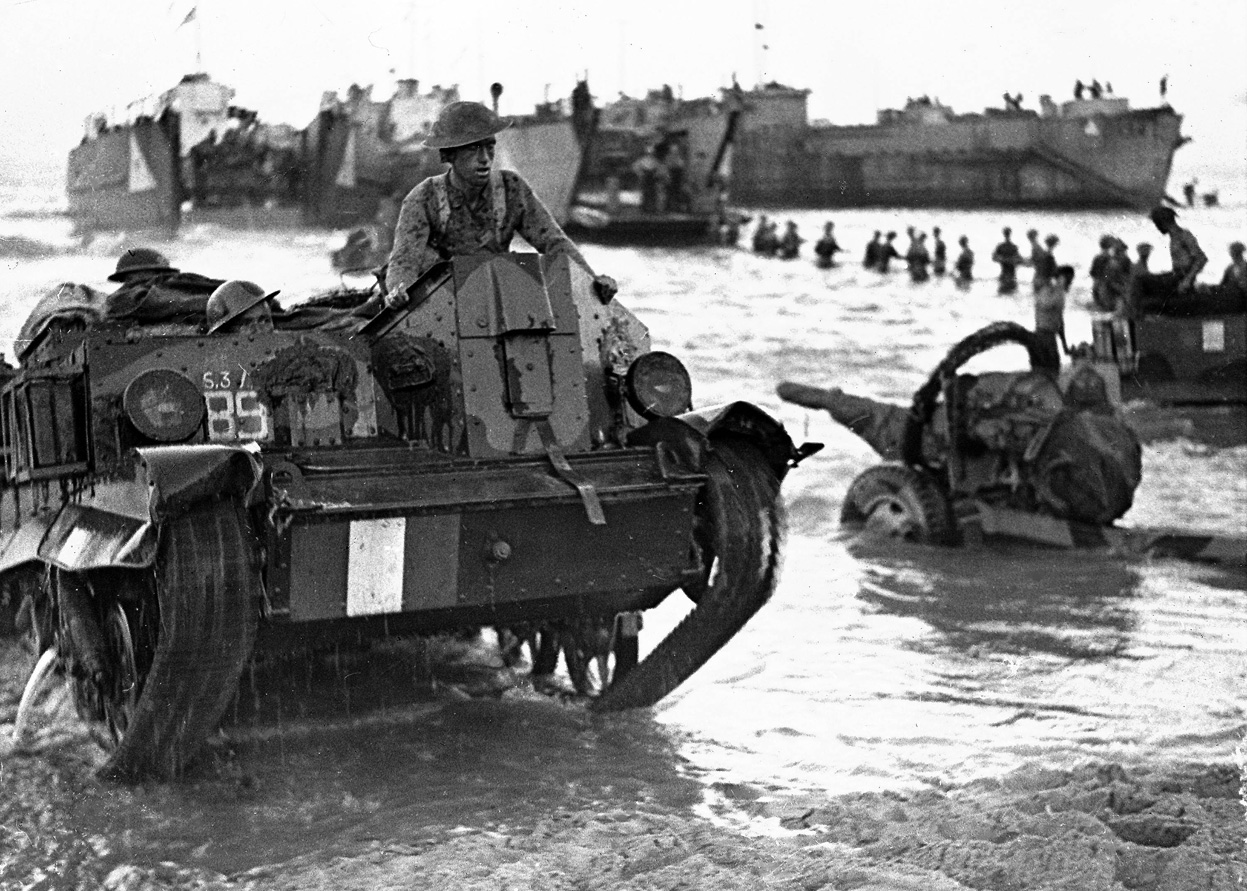 Allied Forces come ashore during the invasion of Sicily, July 1943.  Note the Universal Carrier.