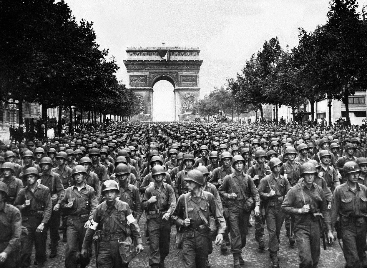 US Twenty-Eighth Infantry Division march along the Champs-Élysées, Paris, France with l’Arc de Triomphe in the background, Aug 29 1944. Photo 2 of 2.