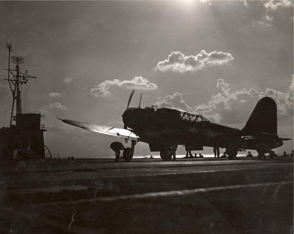 Arresting wires are disengaged from an SB2U Vindicator following a landing aboard the training aircraft carrier USS Sable on Lake Michigan, United States, 1943-44.