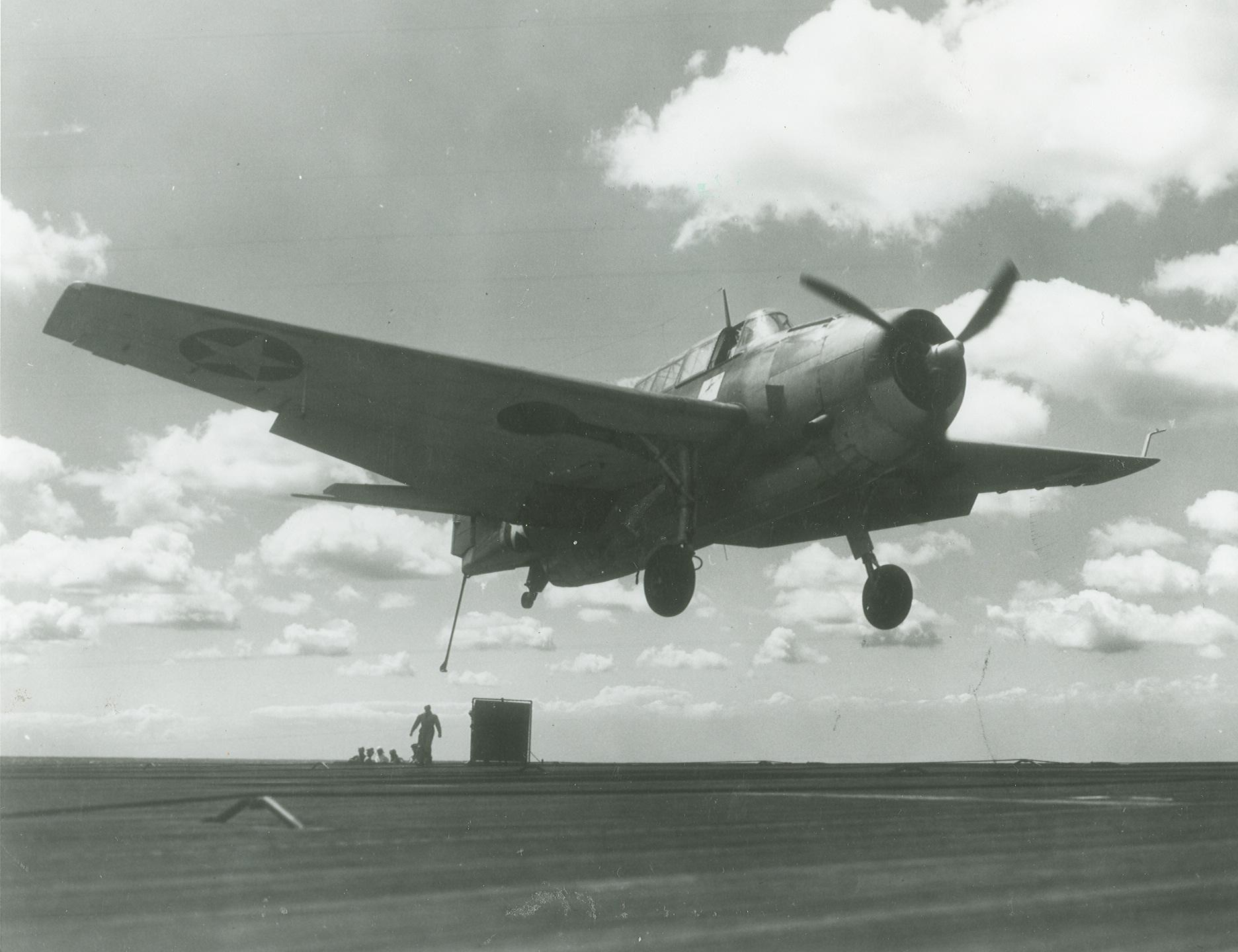 A TBF-1 Avenger with its gear, flaps, and hook down trying to catch the fourth (and last) arresting wire aboard the training aircraft carrier USS Wolverine on Lake Michigan, United States, 17 Aug 1943. Next stop, the barrier.