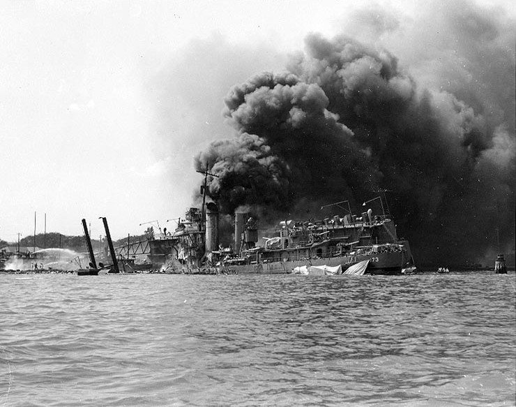 USS Shaw burning in partially sunk Floating Drydock YFD-2, Pearl Harbor, Oahu, Hawaii, Dec 7, 1941. Note men at left playing fire hoses in the direction of the drydock.