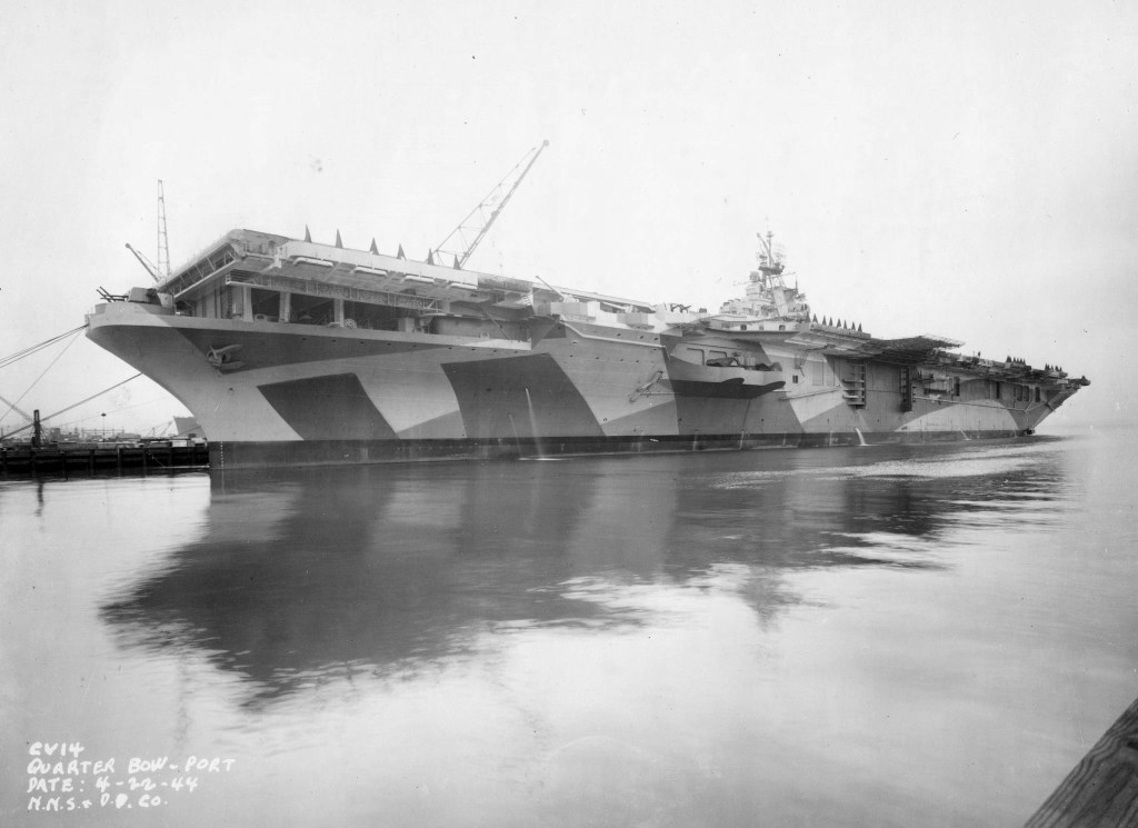 Port side view of Essex-class carrier Ticonderoga receiving final preparations at Newport News Naval Shipyard before being delivered to the US Navy, Newport News, Virginia, Untied States, Apr 22, 1944.
