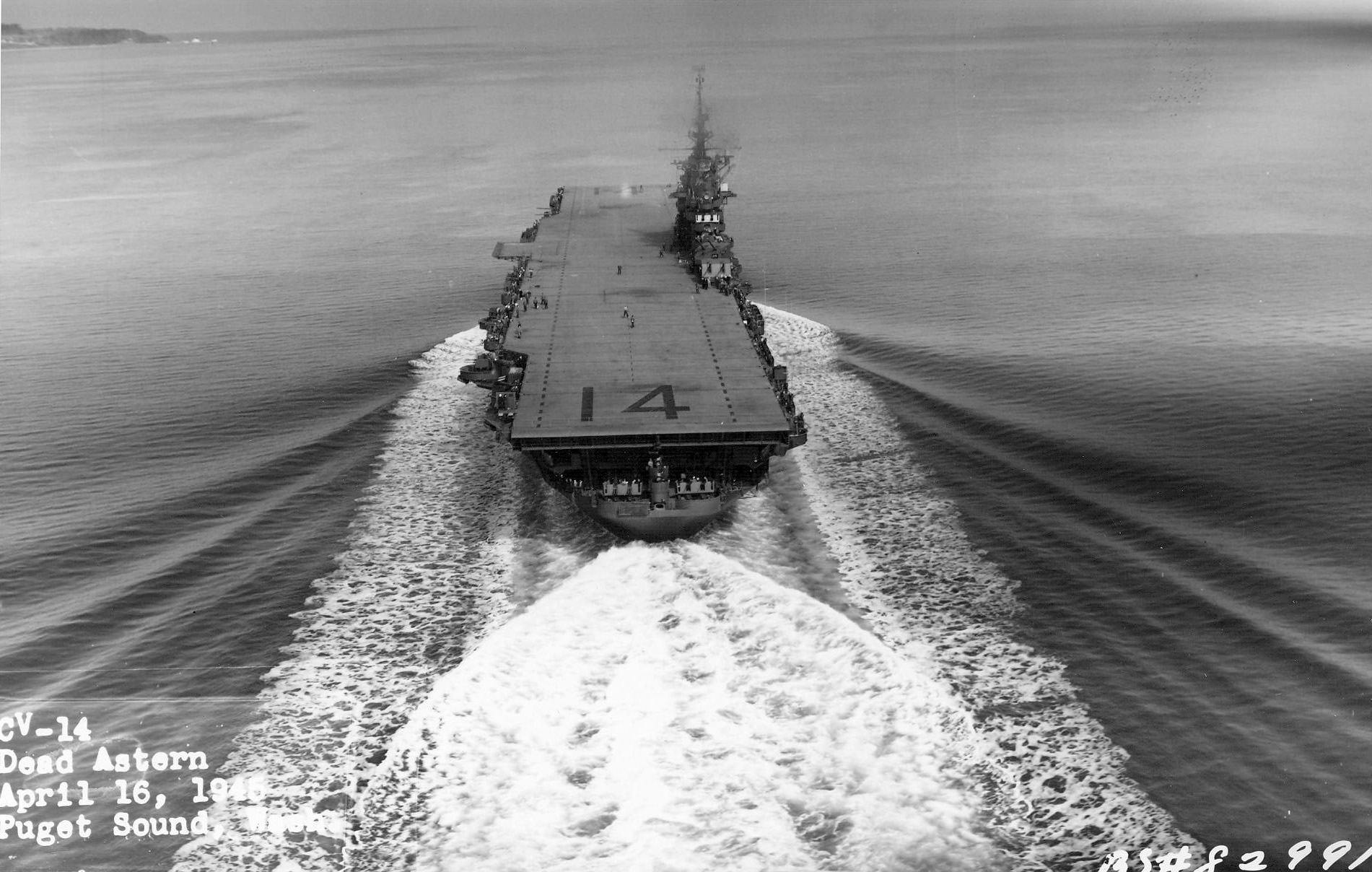 USS Ticonderoga steams down Puget Sound, Washington, United States on her trials after substantial repairs from battle damage, Apr 16, 1945. Photo 2 of 4.