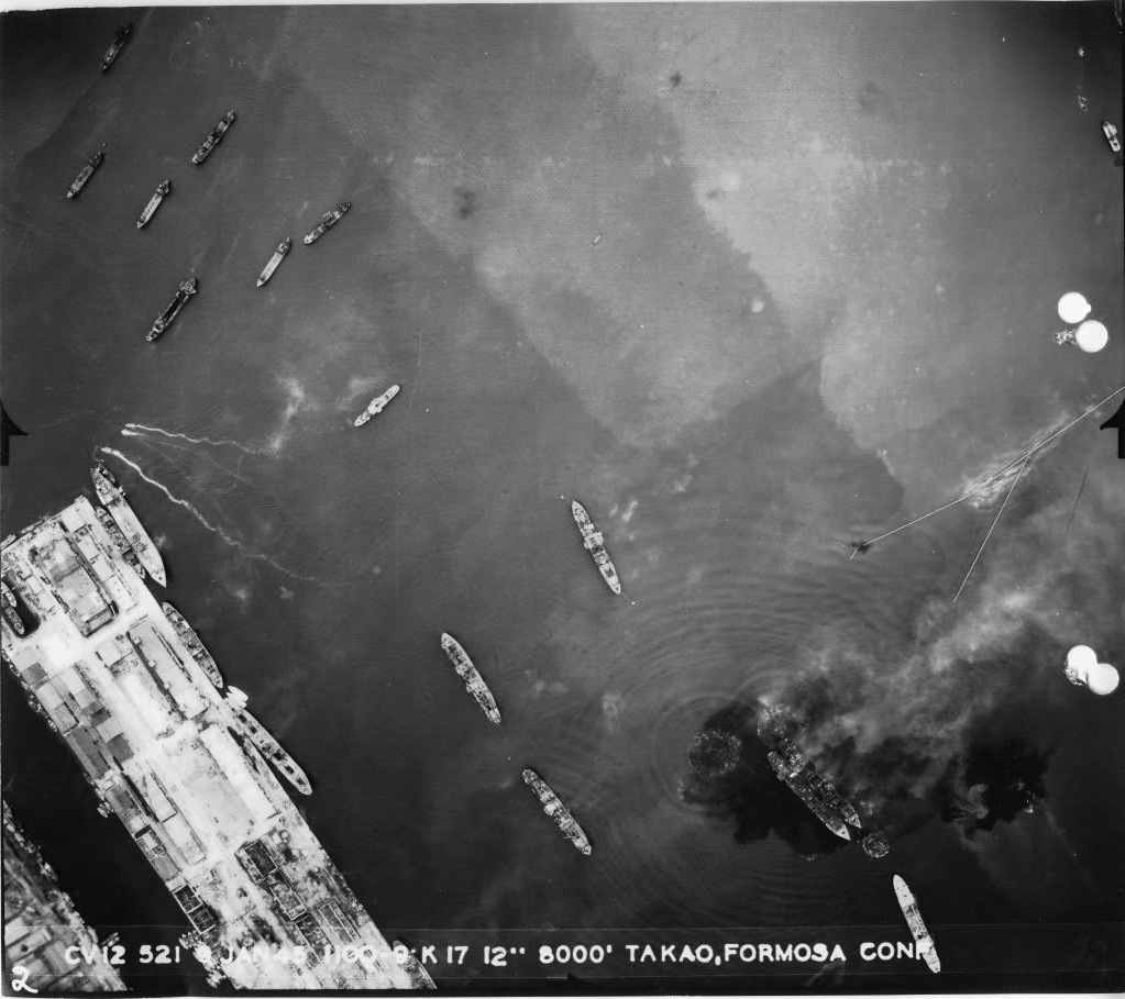 Overhead strike photo of bomb splashes and burning ships in Takao harbor (Kaohsiung) on Formosa (Taiwan), Jan 9, 1945