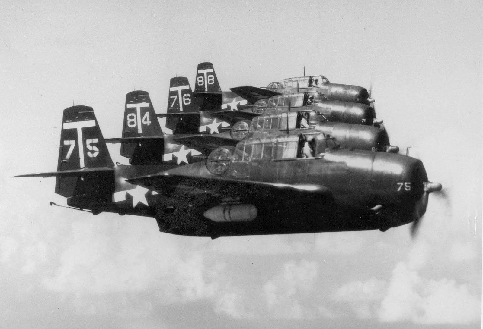 Experienced Avenger pilots of Attack Squadron VA-2A flying from USS Tarawa hold their TBM-3E’s in close formation above San Diego, California, United States, 1946. The white canister under the right wing is a radar pod