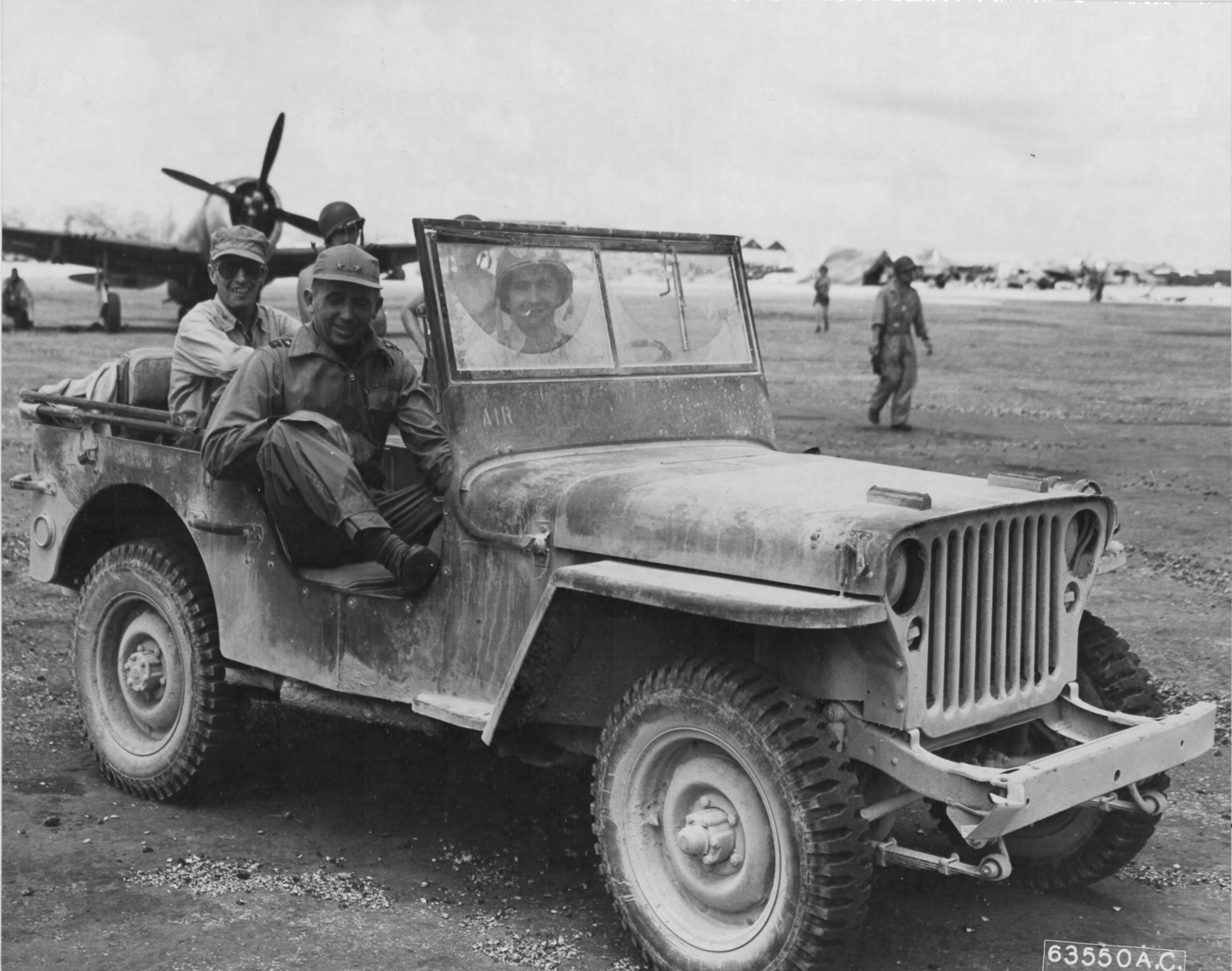 Maj General Willis H Hale (front seat) and Vice Admiral John H Hoover tour Aslito Field, Saipan, Marianas (later Isley Field), Jun 28, 1944, ten days after the area was captured from the Japanese. Note P-47 Thunderbolt.
