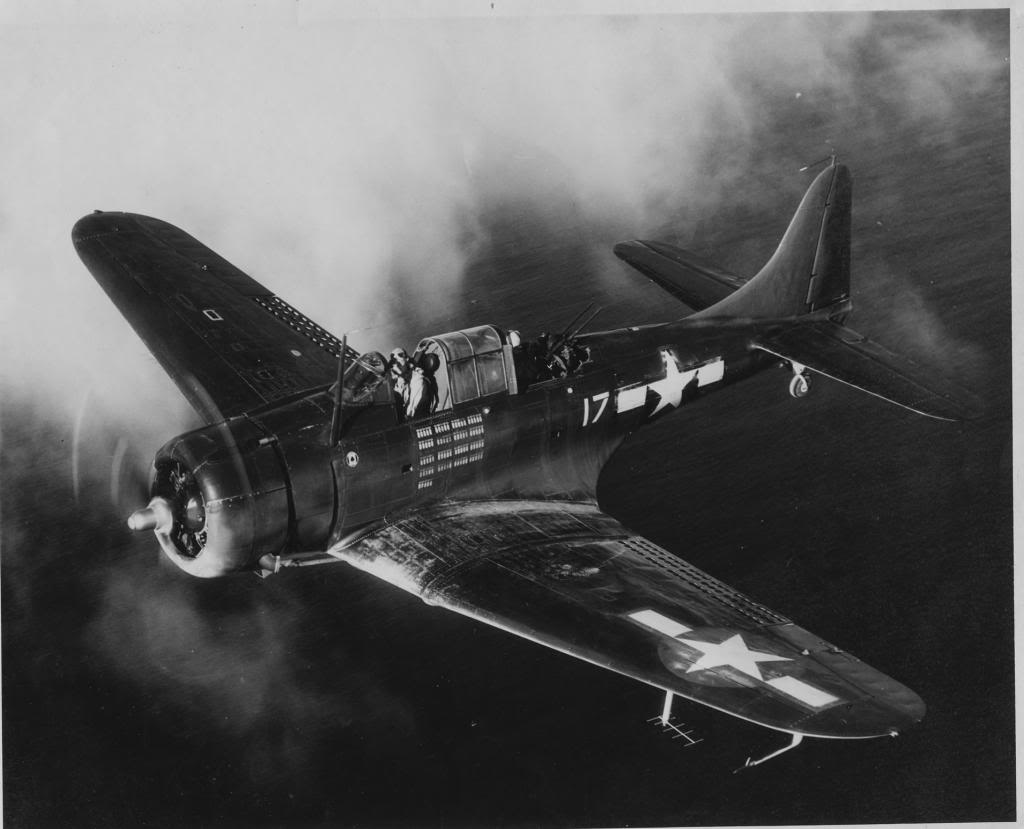 SBD-6 Dauntless scout bomber of Marine Squadron VMSB-231 in flight over the Pacific, 1944. Note the ASB Radar antenna under the wing and the mission markings indicating 85 bombing missions.