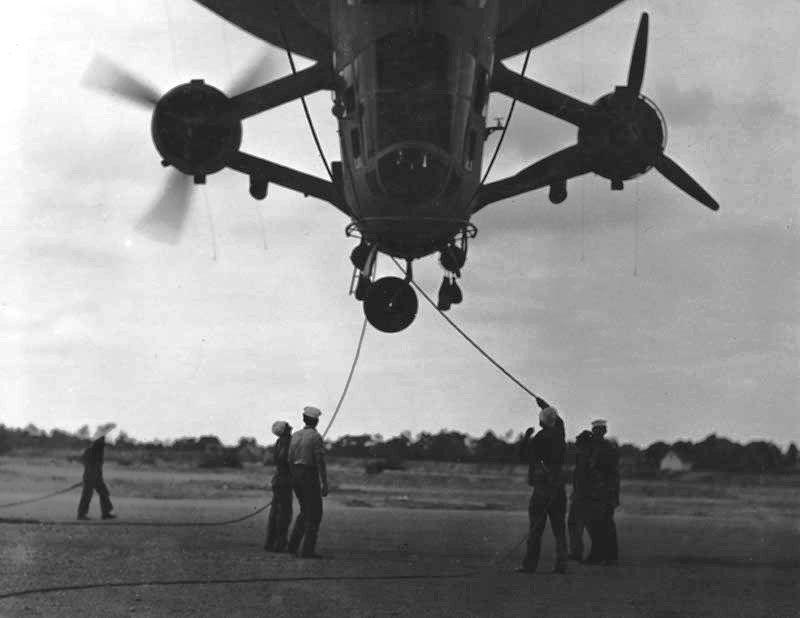 Sailors assist in grounding US Navy blimp K-11, Airship Patrol Squadron ZP-11, during a storm at NAS South Weymouth, Massachusetts, United States, Sep 27, 1942.