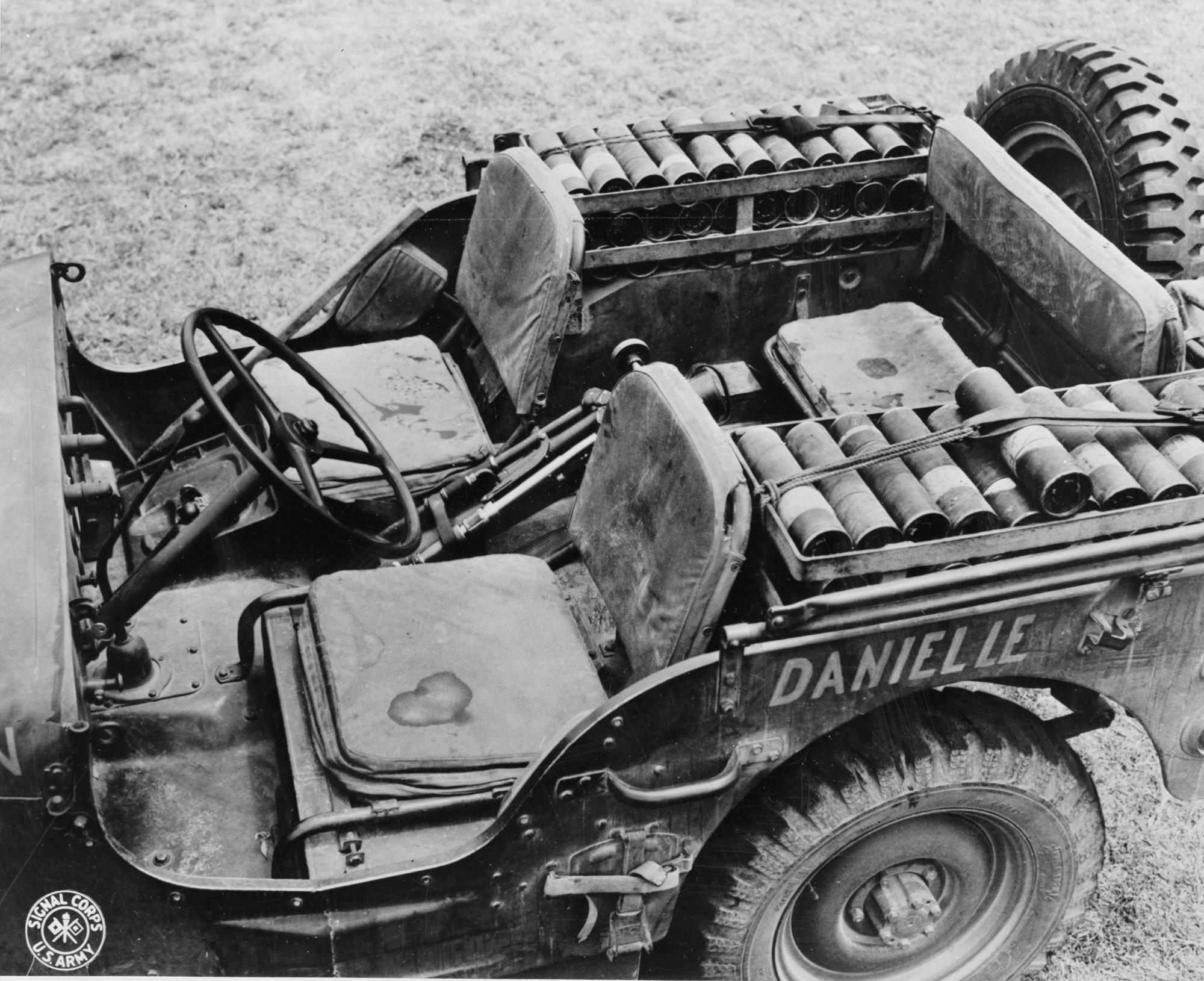 A Jeep packed with mortar shells, a mortar tube between the seats, and the mortar plate on the floor, New Caledonia, 1942.