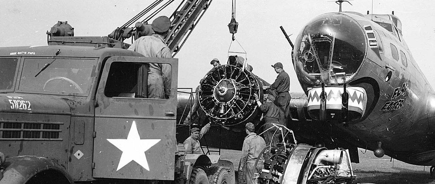 B-17G Fortress 'Flak Eater' of the 305th Bomb Group undergoing an engine exchange at a repair base in England, United Kingdom, 1944-45. Note Federal C-2 wrecker being used as a portable crane.