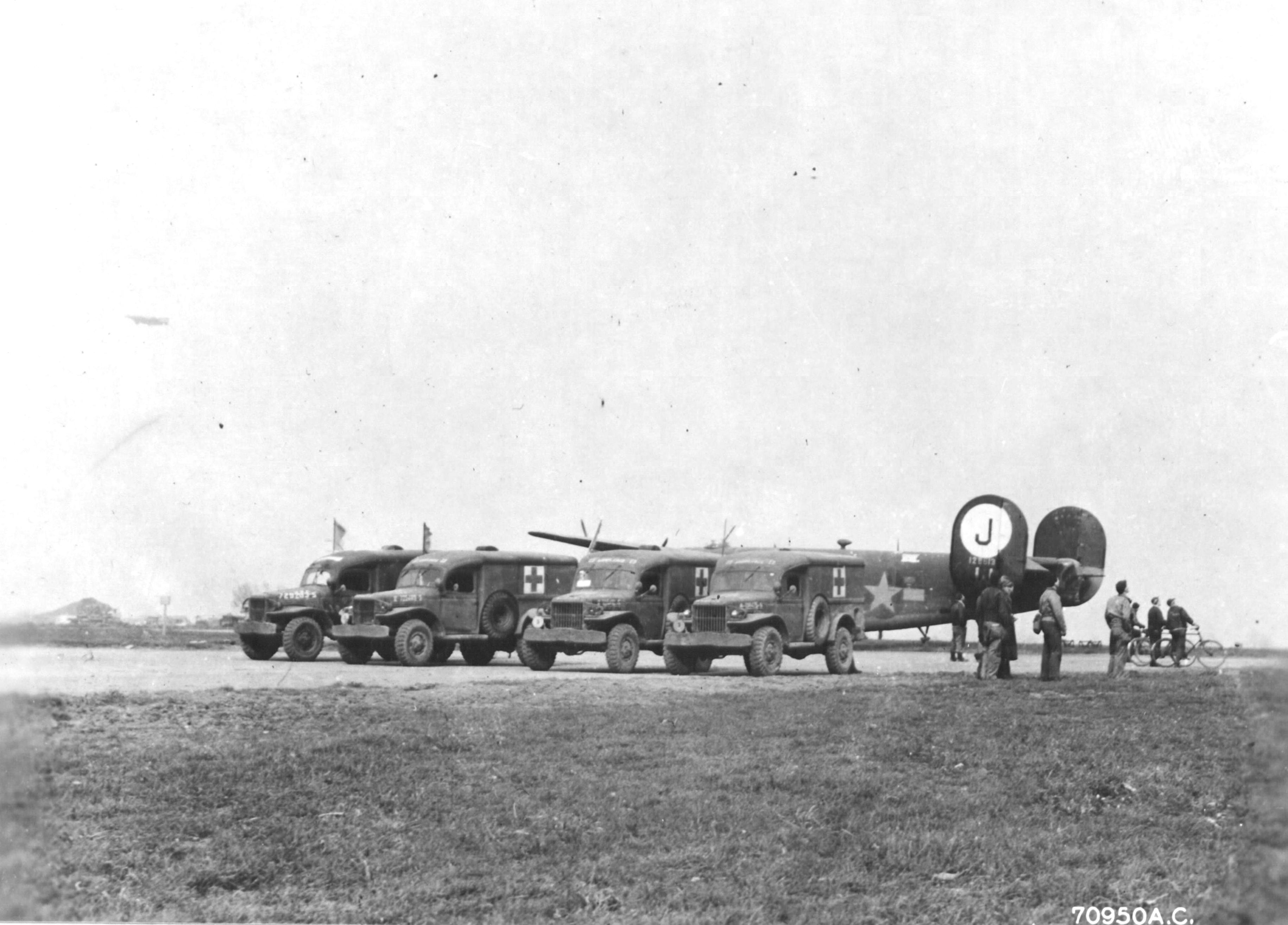 WC-54 ambulances waiting for returning B-24 Liberator bombers of the 453rd Bomb Group at Old Buckenham in England, United Kingdom, Mar 16, 1944