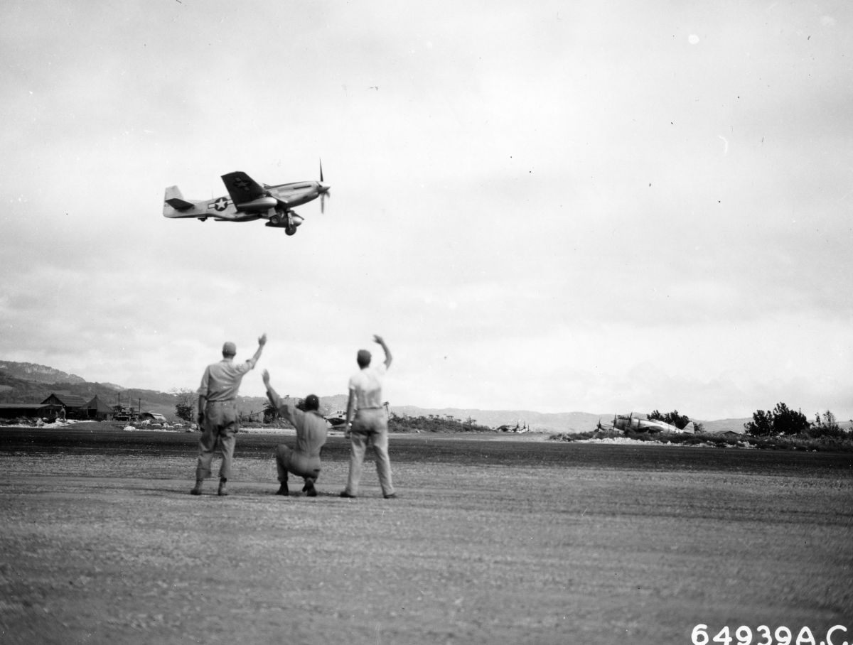 A North American P-51D Mustang of the Vll Fighter Command taking off from Saipan, Mariana Islands for the newly-captured airfield on Iwo Jima, Mar 16, 1945. Note the twin oversized VLR drop tanks.