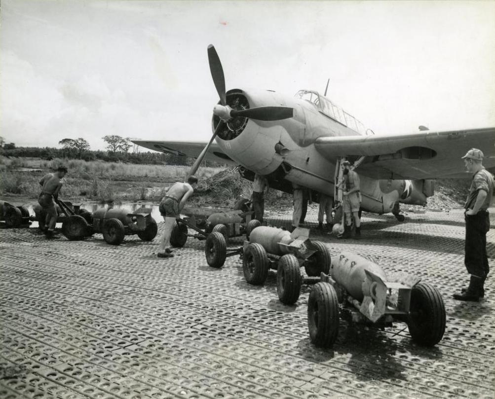 Bombs being brought to a TBF Avenger of United States Navy Torpedo Squadron VT-11 flying from Henderson Field, Guadalcanal, 1942. Note the pierced steel Marsden matting.