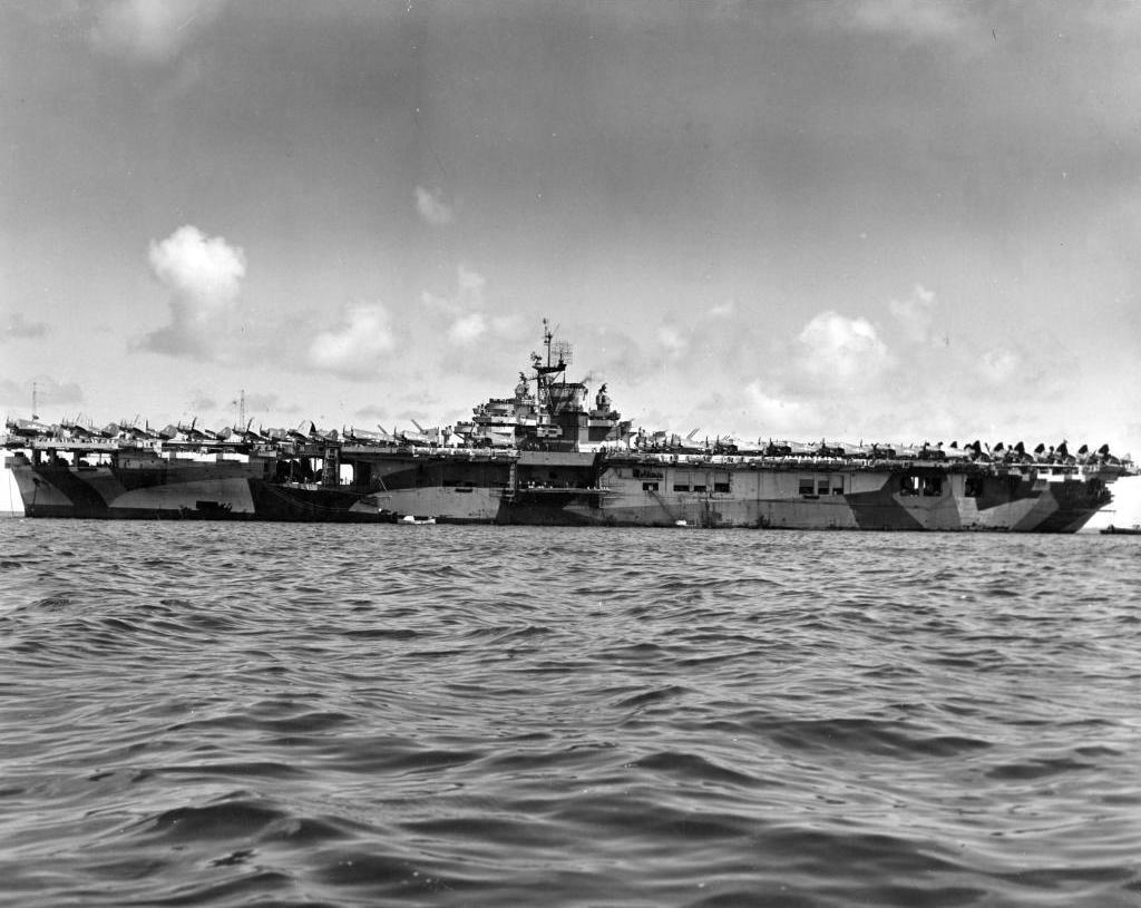 Broadside view of the port side of the USS Hornet (Essex-class) at anchor showing her Dazzle MS33/3a paint scheme, 1944, probably at Ulithi.